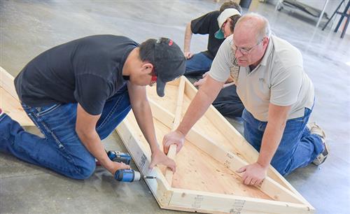 Student learns to use a drill 